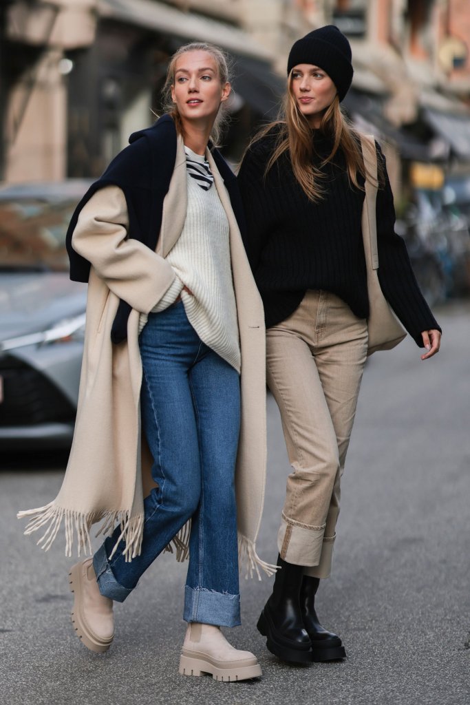 Two girls wearing blue and beige jeans for best jeans for body shape.