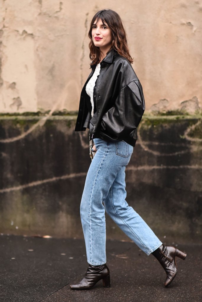 Girl in jeans black leather jacket and boots for best jeans for body shape.