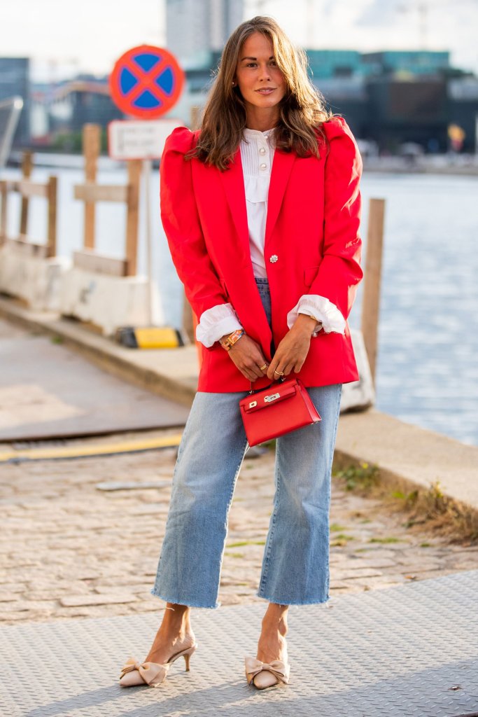 Girl in blue wash jeans, red blazer, white shirt and nude heels.